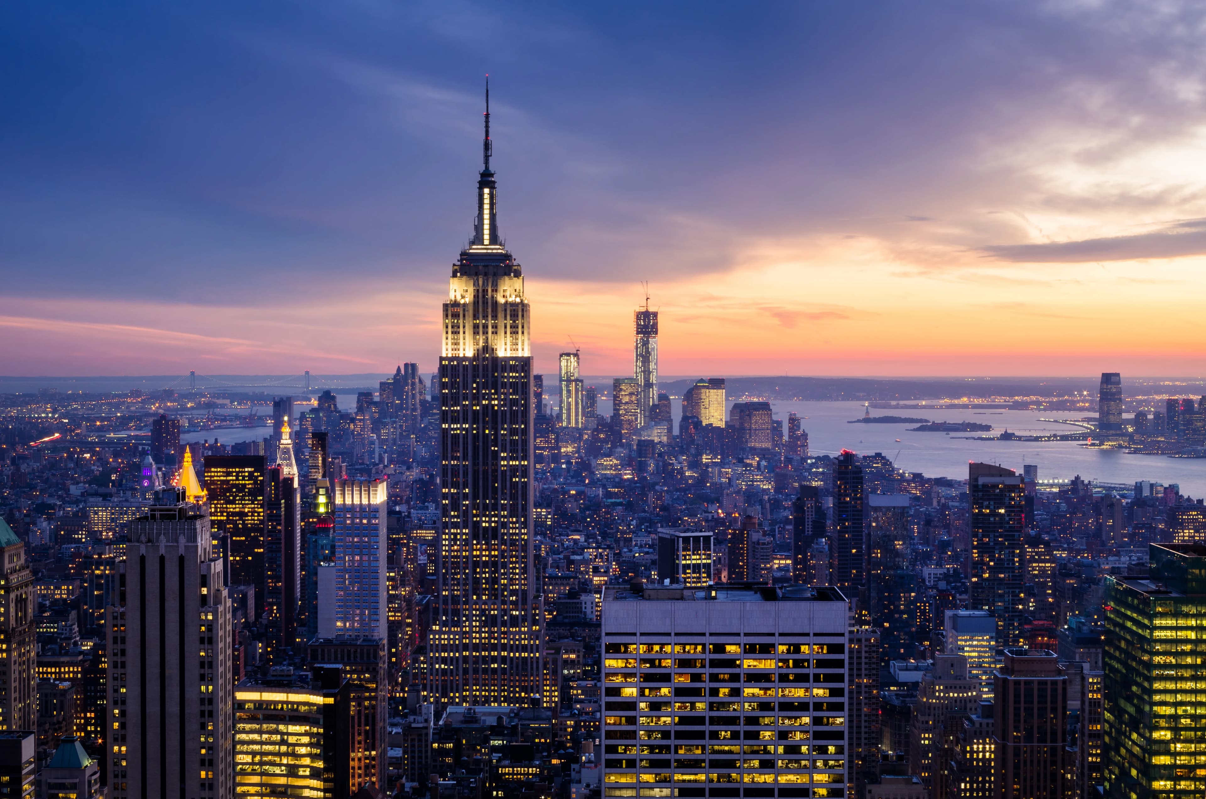Large New York City commercial building exterior under construction at dusk